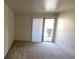 Bright bedroom featuring neutral carpet and access to a private balcony at 5295 Indian River Dr # 305, Las Vegas, NV 89103