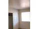 Comfortable bedroom with neutral carpet, closet, and a window at 5295 Indian River Dr # 305, Las Vegas, NV 89103