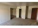 Open-concept living area with neutral carpet and access to the entry door at 5295 Indian River Dr # 305, Las Vegas, NV 89103