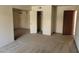 Open-concept living area with neutral carpet and access to the entry door and a closet at 5295 Indian River Dr # 305, Las Vegas, NV 89103