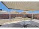 Backyard featuring a covered patio, brick fence, a table, and low maintenance landscaping at 6009 Flowering Plum Ave, Las Vegas, NV 89142