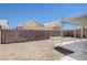 View of the backyard with covered patio, planters, brick perimeter and gravel groundcover at 6009 Flowering Plum Ave, Las Vegas, NV 89142