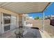 Backyard featuring a covered patio, brick fence, a table, chairs, and low maintenance landscaping at 6009 Flowering Plum Ave, Las Vegas, NV 89142