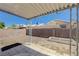 View of the backyard with covered patio, planters, brick perimeter and gravel groundcover at 6009 Flowering Plum Ave, Las Vegas, NV 89142