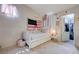 Cozy bedroom featuring bright decor, a pull out bed, and an organized closet at 6009 Flowering Plum Ave, Las Vegas, NV 89142