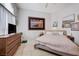 Bedroom showcasing natural light, neutral tones, and modern dresser at 6009 Flowering Plum Ave, Las Vegas, NV 89142