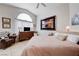 Cozy bedroom features neutral tones, unique artwork, and natural light at 6009 Flowering Plum Ave, Las Vegas, NV 89142