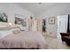 Bright bedroom showing neutral tones, artwork, and adjoining bathroom at 6009 Flowering Plum Ave, Las Vegas, NV 89142