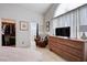 Bedroom featuring closet, ensuite bathroom, and natural light from window at 6009 Flowering Plum Ave, Las Vegas, NV 89142