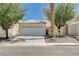 Charming single-story home with a two-car garage, desert landscaping and a tile roof at 6009 Flowering Plum Ave, Las Vegas, NV 89142