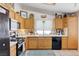 Charming kitchen featuring light wood cabinetry and a full suite of appliances at 6009 Flowering Plum Ave, Las Vegas, NV 89142