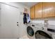 Functional laundry room with modern washer and dryer and ample storage space at 6009 Flowering Plum Ave, Las Vegas, NV 89142
