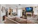 Inviting living room featuring a fireplace, plush seating, and views into the kitchen at 6009 Flowering Plum Ave, Las Vegas, NV 89142