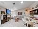 Spacious living room with a fireplace, large sectional, and ample natural light for comfortable, relaxed living at 6009 Flowering Plum Ave, Las Vegas, NV 89142