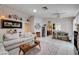 Open-concept living room with tile flooring, comfortable seating, and bright natural light, creating an inviting space at 6009 Flowering Plum Ave, Las Vegas, NV 89142