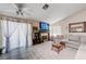 Bright living room with vaulted ceilings, a ceiling fan, large windows, and fireplace offering a cozy and inviting atmosphere at 6009 Flowering Plum Ave, Las Vegas, NV 89142