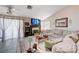Bright living room with tile floors, fireplace, and sliding glass door to patio at 6009 Flowering Plum Ave, Las Vegas, NV 89142