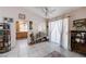Bright living area with tile flooring, large windows, and access to the kitchen offering an open and airy feel at 6009 Flowering Plum Ave, Las Vegas, NV 89142