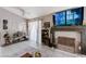 Cozy living room with a fireplace, ceiling fan, and natural light creating a comfortable and inviting gathering space at 6009 Flowering Plum Ave, Las Vegas, NV 89142