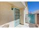 Charming side entrance with a teal-framed security door and blue outdoor light fixture at 6009 Flowering Plum Ave, Las Vegas, NV 89142
