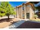 Charming multi-level home featuring a stucco exterior, arched window details and secure gated entry at 605 S Royal Crest Cir # 9, Las Vegas, NV 89169