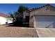 Charming single-story home featuring a desert landscape and a two-car garage at 733 Hitchen Post Dr, Henderson, NV 89011