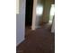 Hallway with plush carpet flooring leading to the bedrooms and bathrooms at 733 Hitchen Post Dr, Henderson, NV 89011
