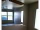 Living room with a ceiling fan, multiple windows, and an open view to other living spaces at 733 Hitchen Post Dr, Henderson, NV 89011