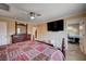 Bedroom features a TV, closet and desk, with neutral paint and carpet at 902 Dianne Dr, Boulder City, NV 89005