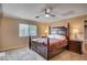 Cozy bedroom featuring a ceiling fan, a window with blinds, and wood furniture at 902 Dianne Dr, Boulder City, NV 89005
