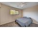 Bedroom with neutral colors, ceiling fan, carpet, and natural light from the window at 902 Dianne Dr, Boulder City, NV 89005
