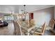 Elegant dining room boasts a glass table, ornate chairs, and stylish lighting, seamlessly flowing into the living area at 902 Dianne Dr, Boulder City, NV 89005