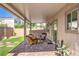 A covered back porch with brick and patio furniture at 9113 Sea Mink Ave, Las Vegas, NV 89149