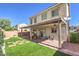 Great backyard including a covered patio, artificial turf, and lush landscaping at 9113 Sea Mink Ave, Las Vegas, NV 89149