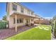 Charming backyard featuring a covered patio, artificial grass, and privacy wall at 9113 Sea Mink Ave, Las Vegas, NV 89149