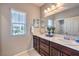 Bathroom offers a dual sink vanity and framed mirror at 9113 Sea Mink Ave, Las Vegas, NV 89149
