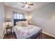 A charming bedroom, features a cozy bed, dark wood floors, and classic decor for a tranquil retreat at 9113 Sea Mink Ave, Las Vegas, NV 89149