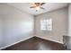 Cozy room features dark hardwood floor, window and electrical sockets at 9113 Sea Mink Ave, Las Vegas, NV 89149