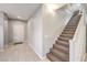 Entryway with tile flooring, a white front door, and a staircase with carpeted steps at 9113 Sea Mink Ave, Las Vegas, NV 89149