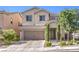 Charming two-story home featuring a well-kept lawn, a two car garage, and stone pillars on the entryway at 9113 Sea Mink Ave, Las Vegas, NV 89149