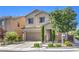 Two-story house featuring a well-kept lawn, a two car garage, and stone pillars on the entryway at 9113 Sea Mink Ave, Las Vegas, NV 89149