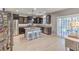 Modern kitchen featuring stainless steel appliances, dark wood cabinets and a granite island with seating at 9113 Sea Mink Ave, Las Vegas, NV 89149