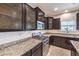 The updated kitchen features stainless steel appliances, granite countertops, and subway tile backsplash at 9113 Sea Mink Ave, Las Vegas, NV 89149