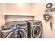 Well-equipped laundry room features modern, stainless steel washer and dryer units, ensuring efficient chores at 9113 Sea Mink Ave, Las Vegas, NV 89149