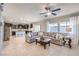 Open living space features large windows, tile floors, sectional sofa, and a view of the kitchen at 9113 Sea Mink Ave, Las Vegas, NV 89149