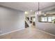 Open-concept floor plan featuring dining room, stairway to second floor, and living room with plenty of natural light at 9113 Sea Mink Ave, Las Vegas, NV 89149