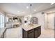 Open concept living space features a kitchen island, spacious living room, and neutral décor at 9113 Sea Mink Ave, Las Vegas, NV 89149