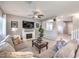 Spacious living room features a cozy fireplace, plush sectional sofa, and bright natural light at 9113 Sea Mink Ave, Las Vegas, NV 89149