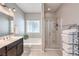 This bathroom is equipped with a tub, enclosed shower and dual sink vanity at 9113 Sea Mink Ave, Las Vegas, NV 89149