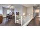 Upstairs loft/office area with wood floors, a ceiling fan, and a view to the stairs at 9113 Sea Mink Ave, Las Vegas, NV 89149